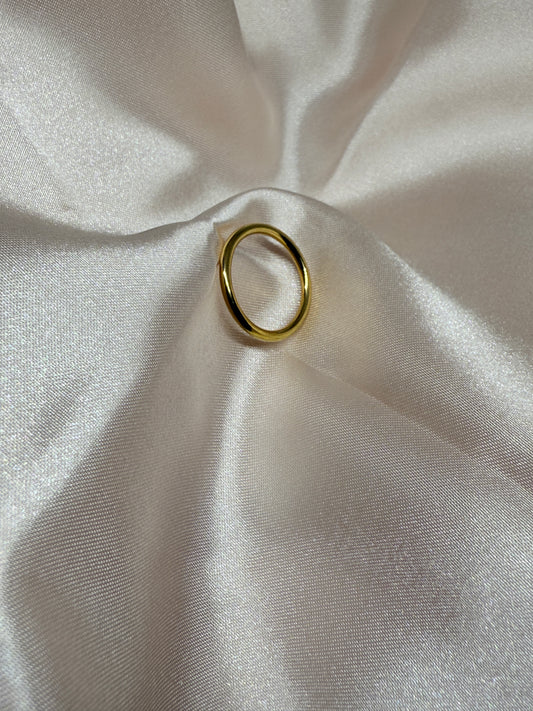 Gold ring on a white fabric background