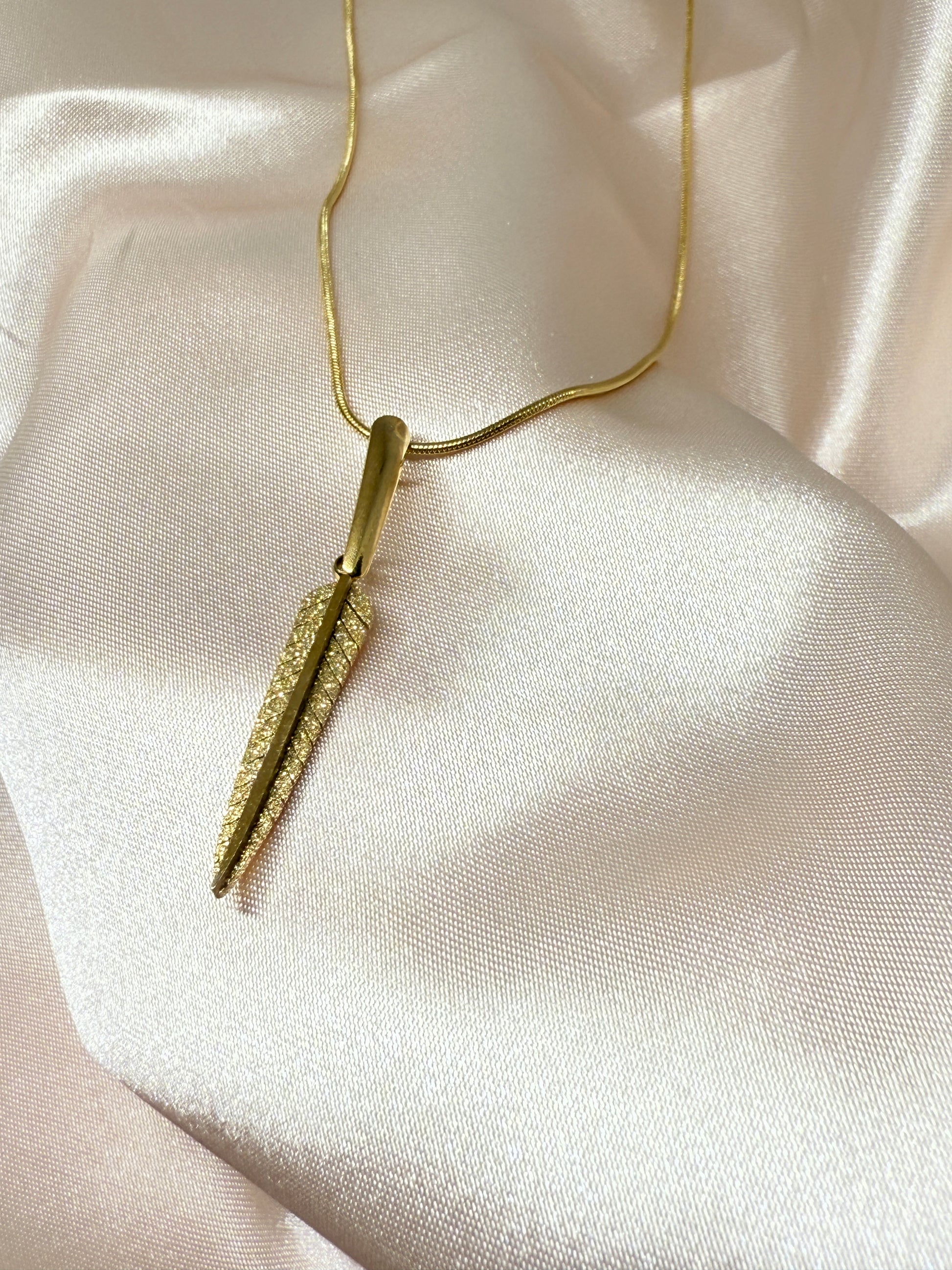 Gold face roller on a soft beige fabric background