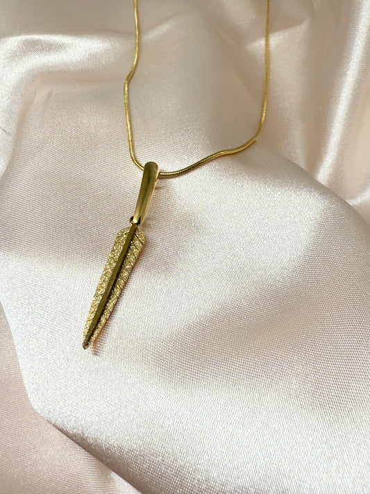 Gold face roller on a soft beige fabric background